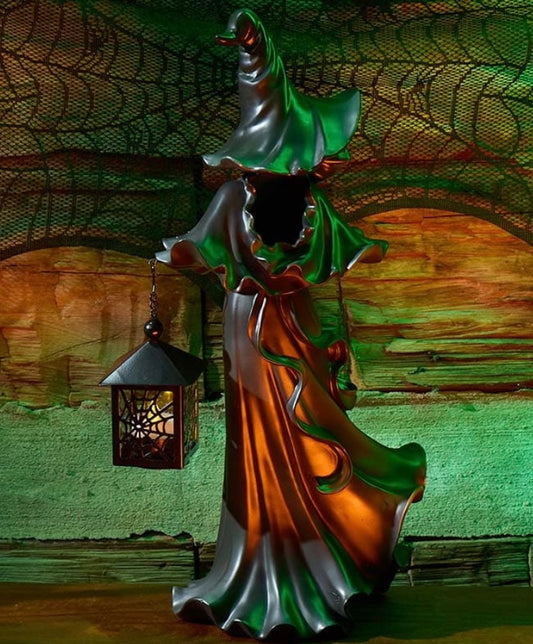 Witch statue with lantern